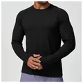 Close-up of a black quick-dry long sleeve athletic shirt featuring thumbholes for men. - S / Tops / Premium Black