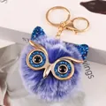 Detailed shot of purple owl pompom keychain with blue glitter eyes and gold hardware - Owl Style (2-10) / Royal Blue Frost