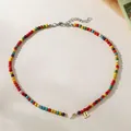 Colorful turquoise bead choker with white heart and gold letter B pendant detail - Letter B