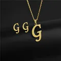 Detailed view of gold stainless steel G alphabet necklace and stud earrings set - Letter G / Gold