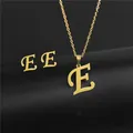 Close-up of golden stainless steel necklace and earrings set featuring letter E. - Letter E / Gold