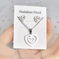 Silver stainless steel jewelry set featuring a layered heart necklace and earrings. - Double Layer Hollow Heart Set (TT-187) / Silver