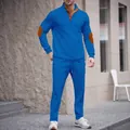 Full detail view of men's bright blue tracksuit with stand collar and brown elbow patches - Blue