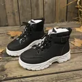 Detail view of black winter high-top boots with warm white faux fur lining and thick white sole - 35 / Plush Lined High Top / Black