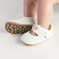 Detailed view of white baby girl pre-walker shoes featuring breathable mesh fabric and bow - White