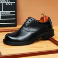 Elegant black leather brogue Derby shoe for men featuring refined wingtip detailing. - Black