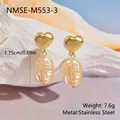 Gros plan de boucles d'oreilles cœur doré et perle baroque sur un coquillage - Cœur Doré Perle Baroque (NMSE-M553-3) / Or 18 carats / Or