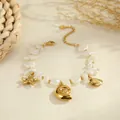 Close-up of ocean-themed gold stainless steel bracelet with shell and starfish charms. - Bracelet Style (NMSB-L333-2) / 18K Gold