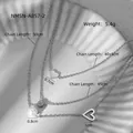 Vue détaillée d'un collier multi-rangs avec cœur et perle, incluant les dimensions. - Acier