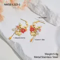 Detailed view of stainless steel ginkgo earrings with red flower beads and tassel design - Earrings (NMSE-L323-3) / 18K Gold
