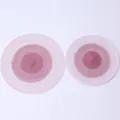 Close-up view of two circular gradient woven cotton placemats in pink and white tones. - 12-Piece Set / Burgundy