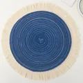 Macro view of a blue woven round placemat with delicate cream cotton fringe detail - 12-Piece Set / Blue