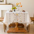 Detailed view of a cream embroidered floral tablecloth featuring an elegant tassel fringe - Qiongzhi Plain Weave / 140*220cm / Brown