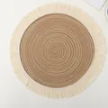Boho style round woven table placemat in brown featuring cream cotton fringe tassels - Brown