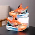 Bright orange and blue boys' athletic sneakers featuring an easy rotary dial lace system - Orange