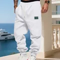 Men's white fleece joggers featuring a drawstring waist and elastic cuffs in outdoor setting - S / Bottoms / White