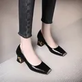 Detail view of black snake pattern square toe pumps with metallic heel decoration - 34 / Black
