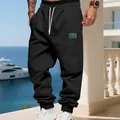 Mens black fleece joggers with white drawstrings in a casual outdoor setting - S / Bottoms / Black