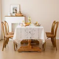 Detailed lifestyle shot of an embroidered floral tablecloth with elegant tassel fringe - Qiongzhi Plain Weave / 140*220cm (6-8 People) / Blue