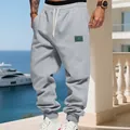 Casual grey fleece joggers for men featuring a loose fit drawstring waist in an outdoor setting - S / Bottoms / Light Gray