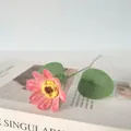 Détail macro d'une marguerite artificielle vintage rose avec des feuilles vertes - Rose foncé