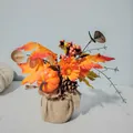 Detailed view of harvest festival pumpkin arrangement with maple leaves and burlap base - Orange Pumpkin Tree
