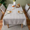 Detailed view of linen-textured tablecloth with white embroidered stripes and tassels. - 100*140cm / Brown