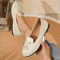 Elegant cream leather tassel loafers featuring a soft sole for stylish and comfortable daily wear. - White