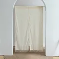 Detailed view of white fabric door curtain with orange dots and tassel fringe in archway - Daisy Double Opening / 85x90cm / Beige