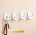 Pack of 4 modern white and silver-plated adhesive wall hooks for home organization - Set of 4 / White
