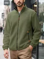 Close-up of men's olive green polar fleece zip-up jacket in an outdoor street setting - Army Green