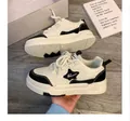Baskets à plateforme pour filles en noir et blanc avec logo étoile et style décontracté. - Noir