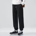 Stylish men's black casual jogger sweatpants with elastic cuffed ankles for sports and fitness - M / Unlined / Black