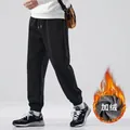 Detailed view of men's black fleece-lined joggers featuring warm inner fabric texture - M / Fleece Lined / Black