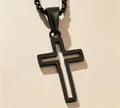 Close-up shot of a modern black hollow-out cross pendant necklace with hip-hop aesthetic design - Black