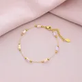Close-up of gold titanium steel bracelet with six iridescent pink rectangular crystals - Iridescent Pink