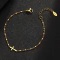 Detailed macro view of gold stainless steel cross bracelet with pink enamel beads - Gold Purity / Pink