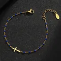 Macro view of gold-plated stainless steel bracelet featuring blue enamel beads and cross - Gold Purity / Dark Blue