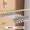 Close-up detail view of white non-marking stainless steel pants hangers with metal clips - Enhanced Version / White