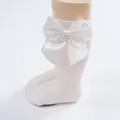 Cute white baby knee high socks with a large decorative satin bow for toddler girls - White / Size S (0-1 Year)