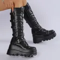 Detailed close-up of black punk platform boots featuring bat buckles and metal rivets - 35 / Black