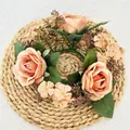 Elegant artificial peach rose candle ring wreath on a rustic woven mat - Dark Champagne