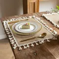 Close-up detail of a rustic farmhouse burlap placemat with elegant white tassels on wood - 38cm Round / Small Broom Fringe