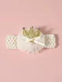 Detailed view of baby headband with golden glitter crown and lace bow decoration - Beige