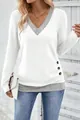 Detailed close-up view of the V-neck color-block long sleeve top with side button accents - S / Tops / White