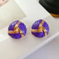 Macro detailed shot of vintage purple enamel gold earrings with twisted design - Premium Purple
