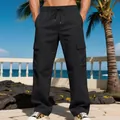 Detail of men's loose black multi-pocket cargo pants with drawstring waist in outdoor scene. - XS / Bottoms / Black