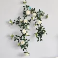 Detailed view of white artificial rose vine with green leaves on a clean wall - Rose Vine / White