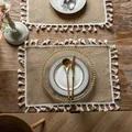 Rustic jute placemat with white tassel trim shown on a wooden farmhouse table - 38cm Round / Small Broom Fringe