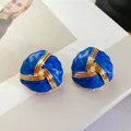 Detailed view of vintage blue enamel stud earrings with twisted gold-tone accents and 925 silver needles - Premium Blue